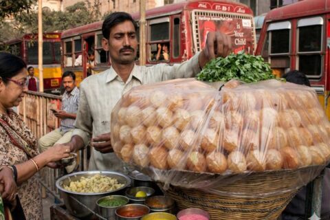 Kolkata street vendor preparing fuchka with tamarind water